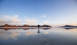 © Gary Parker/Stocksy - A man walking on a salt lake in the early morning