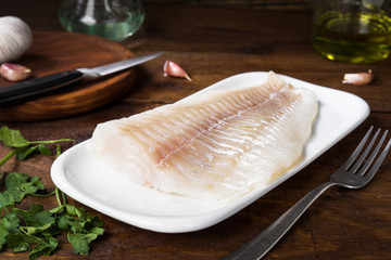 fresh cod fillet without cooking in rustic wood