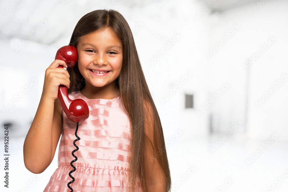 Smiling little girl talking on the phone Stock Photo | Adobe Stock