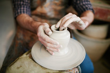Skilled Potters Hands Gently Shaping Clay Vase On Throwing Wheel