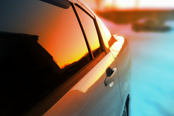 car at sunset, reflected in mirrors