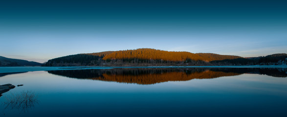 Wall Mural - Beautiful twilight reflection in a mountain lake panorama, Oker dam in National Park Harz in Northern Germany