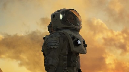 Wall Mural - low angle shot of female astronaut in the space suit looking around alien planet. advanced technolog