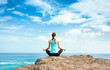 Young woman meditating by the sea. Yoga meditation and relaxation. 