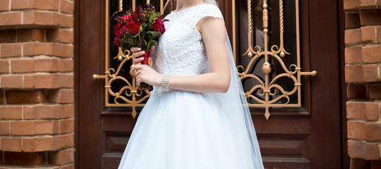 Wall Mural - Beautiful wedding bouquet of flowers in hands of the bride