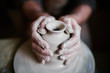 © Clique Images/Stocksy - Potter shaping beautiful clay vase on wheel