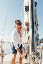 Mature Man Working On A Sailboat.