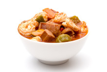A Bowl Of Cajun Seafood Gumbo On A White Background