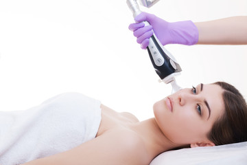 Doctor woman making to patient laser skin resurfacing in aesthetic medicine.