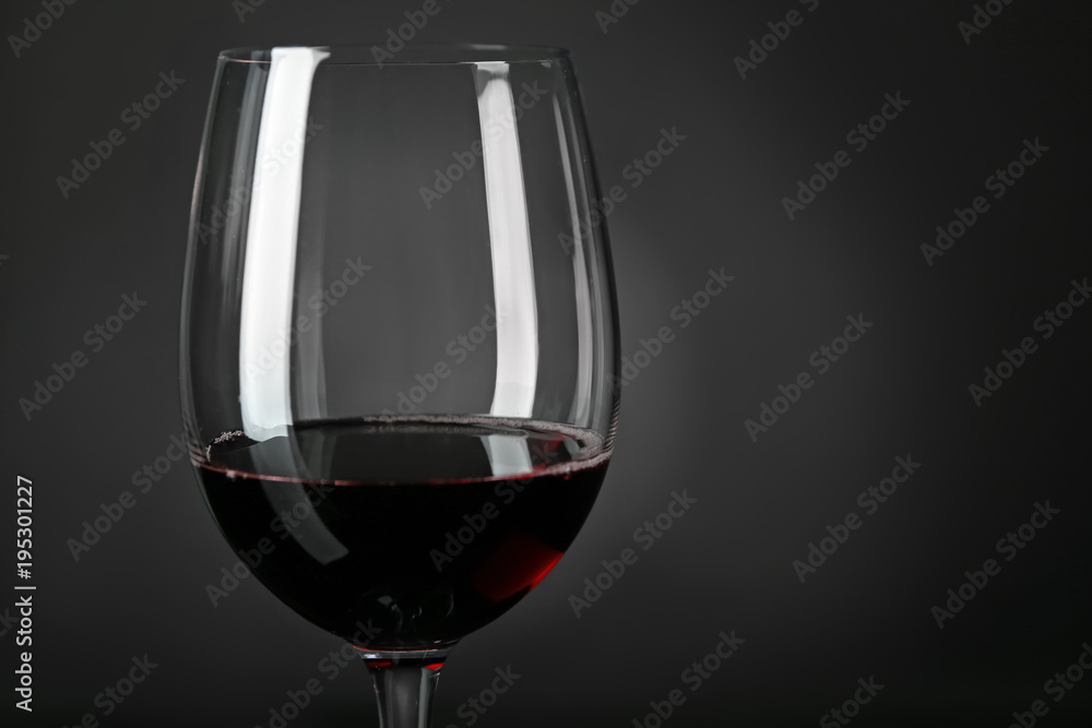 Glass of red wine on dark background, closeup