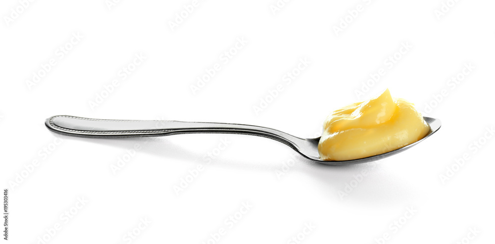 Tasty vanilla pudding in spoon on white background - obrazy, fototapety, plakaty 