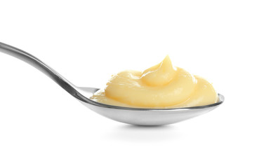 Wall Mural - Tasty vanilla pudding in spoon on white background