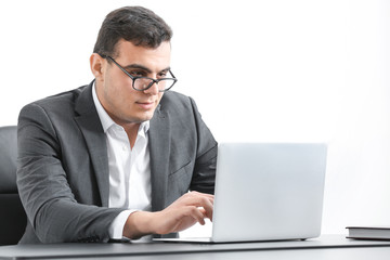 Wall Mural - Young man in office wear working with laptop at table