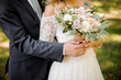 Close up photo of a bridegroom embracing a bride