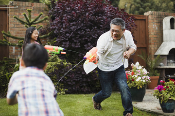family having a water fight