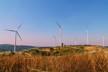 Wall Mural - wind turbines on the hill with blue sky background