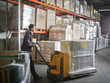 © Westend61 - Man operating pallet jack in storehouse