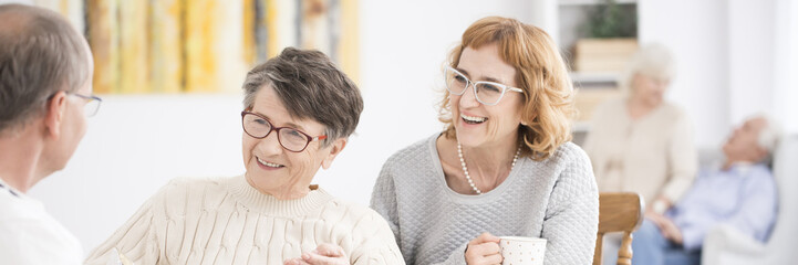 Wall Mural - Smiling senior women during meeting