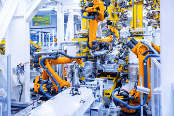Wall Mural - robotic arms in a car plant