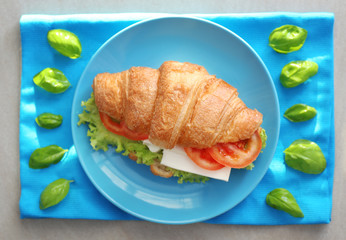 Sticker - Plate with tasty croissant sandwich on table