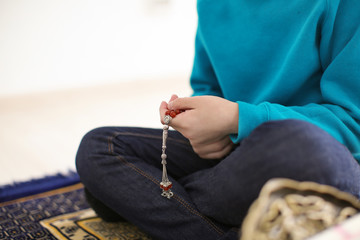 Wall Mural - Little Muslim boy praying, indoors