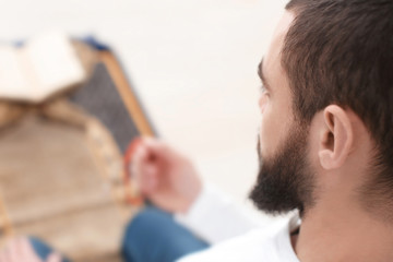 Wall Mural - Young Muslim man praying, closeup