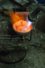 Wall Mural - Craft jewelery making with professional tools. Macro shot. A handmade jeweler process, manufacture of jewellery. Melting metal