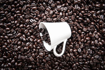 White coffee mug on coffee bean.