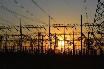 The silhouette of the evening electricity transmission pylon