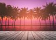 Empty wooden terrace over tropical island beach with coconut palm at sunset or sunrise time