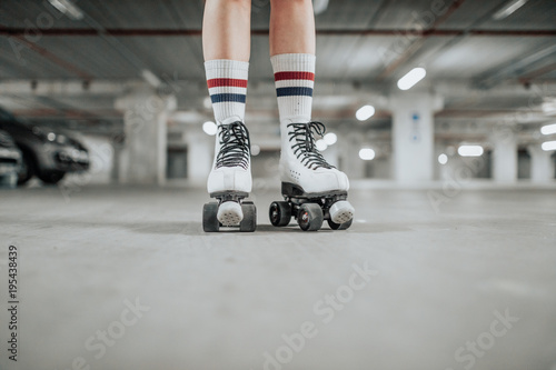 Cuadros en Lienzo young sexy woman rollerskating in an urban looking garage and posing in a hipste
