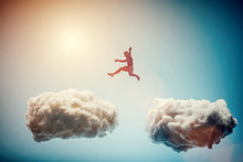 Man Jumping From One Cloud To Another. Challenge.