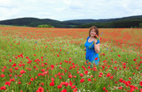 Fototapeta Kuchnia - Happy smiling woman on the poppy field.
