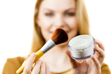 Smiling woman holding make up brush