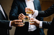 © VAKSMANV - Multiethnic group of businessmen spending time together drinking