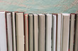 © Iren Moroz - Pile of various books on bright wooden background. With copy space for your text