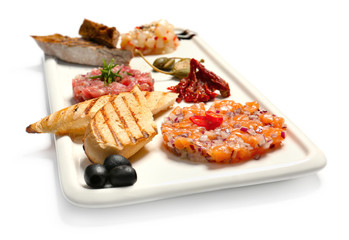 Wall Mural - Plate with delicious fish tartars and snacks on white background