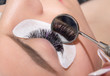 Beautiful woman with long eyelashes in a beauty salon eyelash extension procedure lashes close up