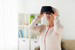 © Syda Productions - old woman in virtual reality headset or 3d glasses