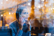 © mnelen.com - pensive woman sits outside the window and speaks by phone