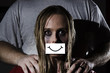 © grufnar - concept abused woman with gauged mouth and a fake smile hiding the abuse and a man standing behind her with his hands on her shoulders