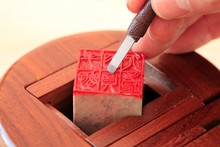 Chinese Craftsman Carving A Stone Seal