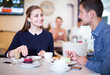 © JackF - Smiling woman and boyfriend enjoying sweet dessert