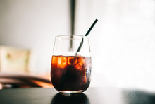 Black Cold Brew Coffee With Ice Cubes In A Glass. Hipster Coffee Shop. Minimalism Drink Photography