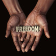 © Giovanni Cancemi - African hand with text Freedom