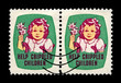Help Crippled children. Girl with Easrer lily flower. Easter Seals Stamp aka Christmas seals since 1919, circa 1950. canceled vintage postal stamp printed in USA isolated on black background.