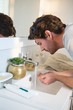 © Wavebreak Media - Man washing his face with water in bathroom