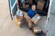 © Rido - Delivery man unloading parcel