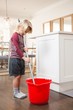 © Wavebreak Media - Boy holding floor mop with bucket