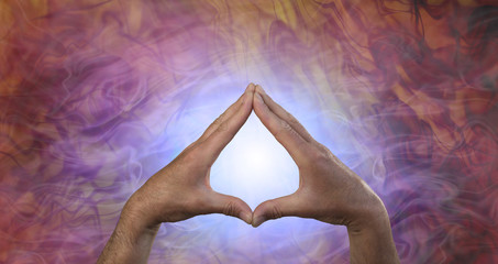 Quantum Healing Energy - male hands creating a leaf shape against a glowing blue light and flowing quantum healing energy field
